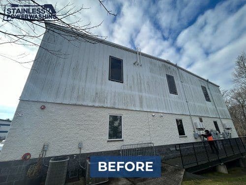 Before image of a stained building exterior awaiting power washing services.