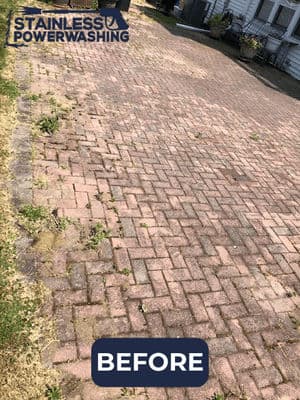 Before image of a paver driveway with weeds and dirt, highlighting the need for power washing.