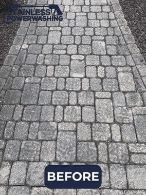 Before image of a dirty, paved stone walkway needing power washing.